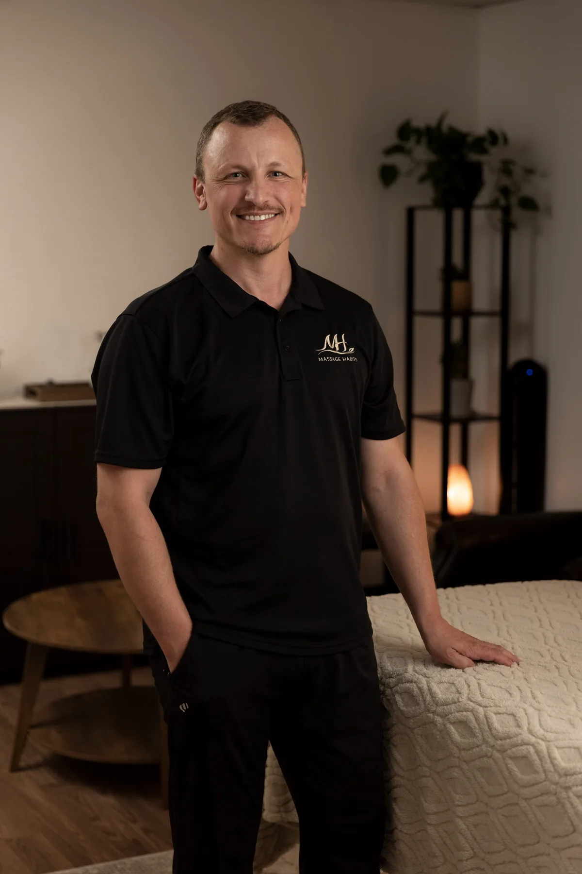 Dorian standing beside the massage table in his Mission Valley treatment room.